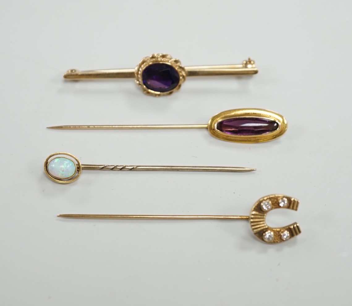 Three assorted yellow metal and gem set stick pins, including 9ct gold and diamond set horseshoe, 58mm and a modern 9ct gold and gem set bar brooch, gross weight 9.2 grams.